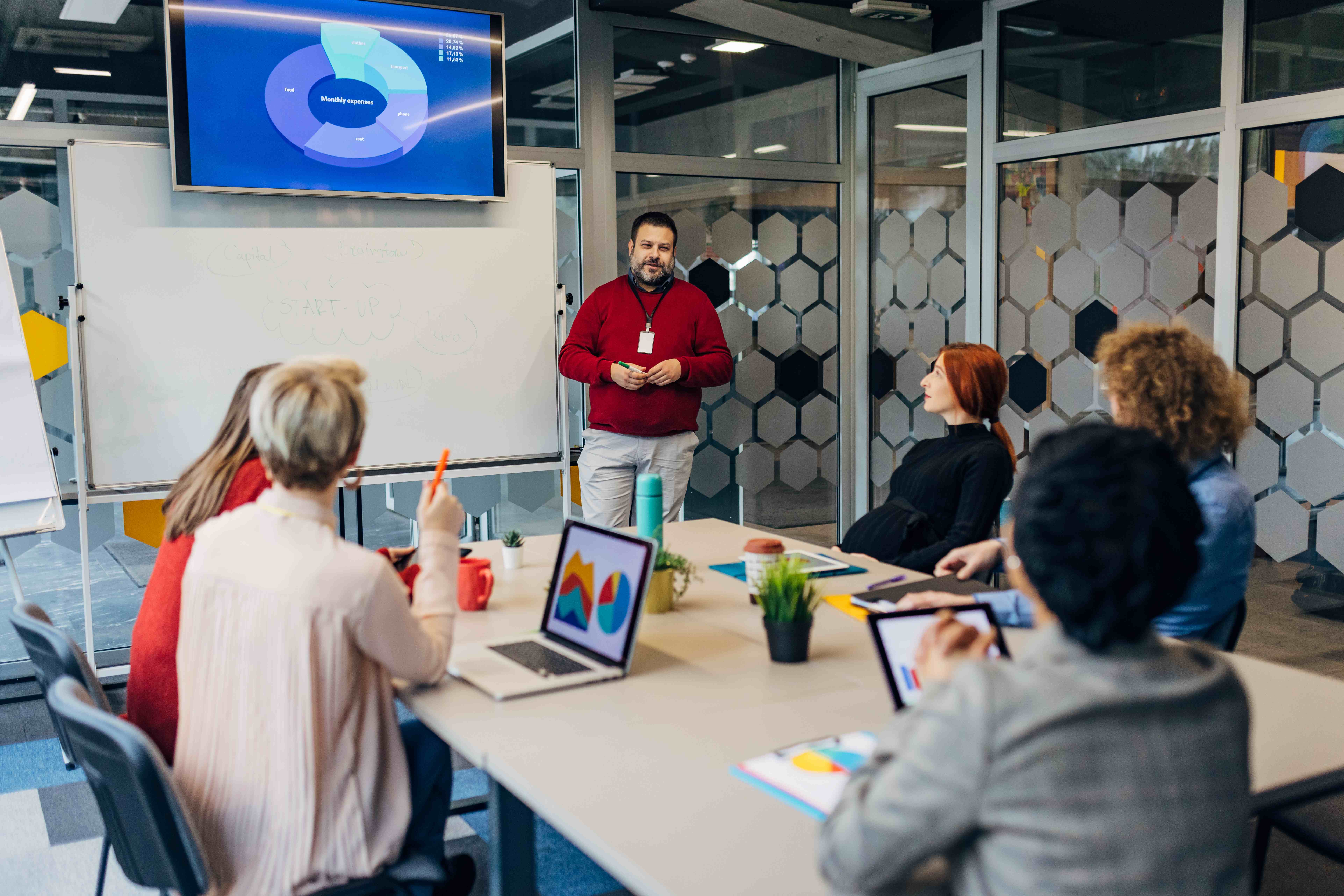 Instructor presenting to team in modern training room